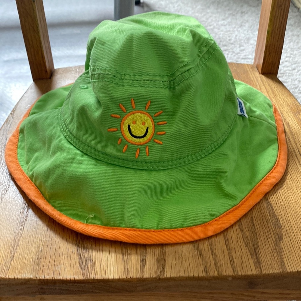 Cute kid’s hat, up to 7yrs old. Color lime green with orange trim.